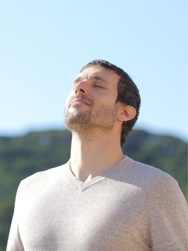 Man relieving stress with deep breathing exercises.