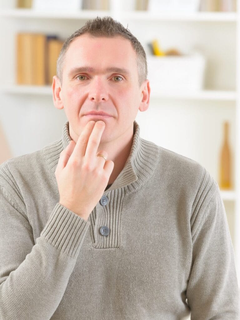 Image: Man tapping on his chin.